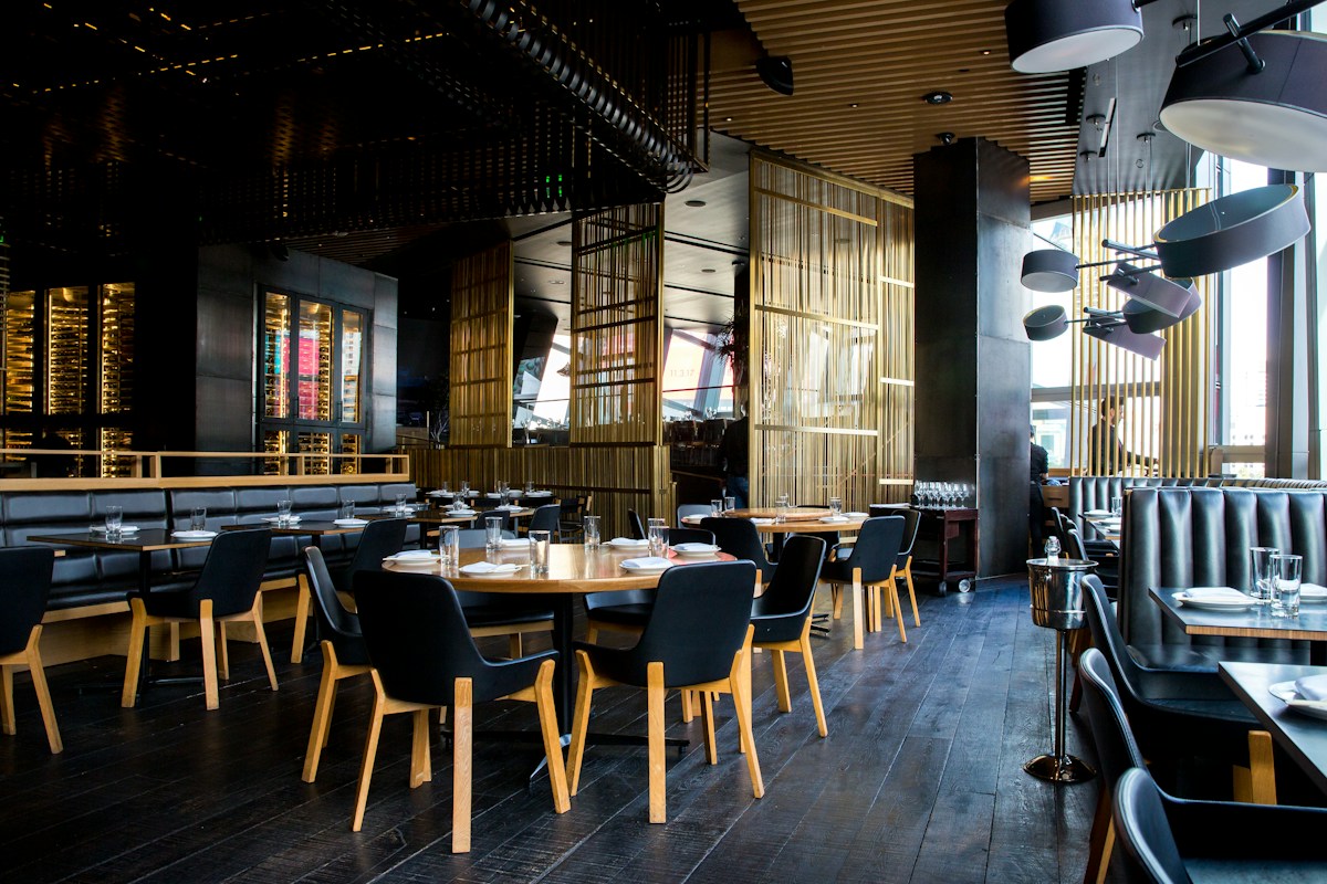 Warm restaurant interior with tables and hanging lights
